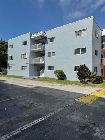 Front view of a multi-story residential building with balconies.