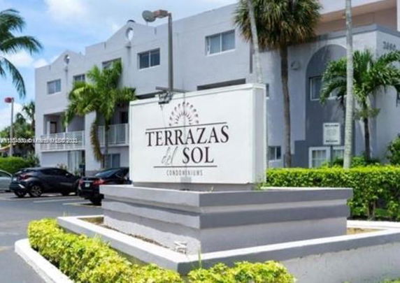 Front view of a condominium building with multiple floors.