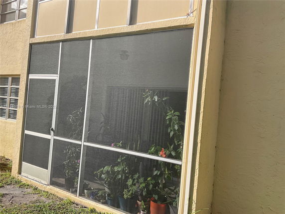Front view of a building with a screened patio area.