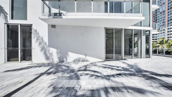 Front view of a modern building with large glass windows.