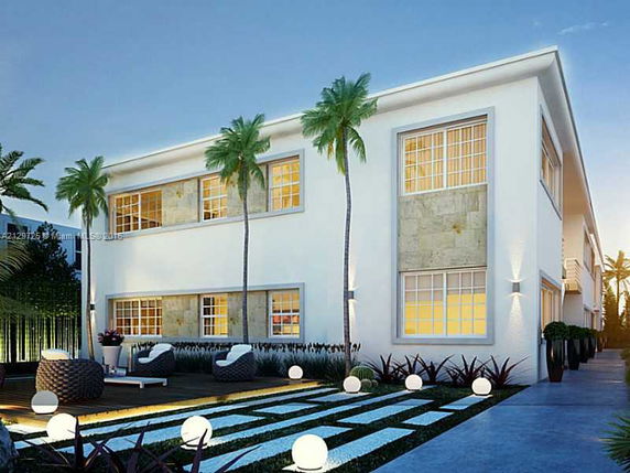 Front view of a modern two-story building with large windows and decorative outdoor lighting.