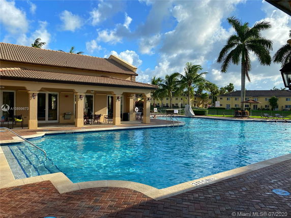Large swimming pool with a surrounding patio area.