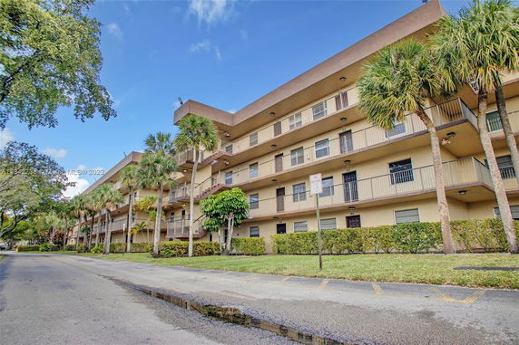 Front view of a multi-story residential building with balconies.