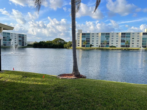 View of surrounding water body and buildings with a grassy foreground.