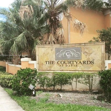 Front view of a building with a sign reading 'The Courtyards at Davie'.