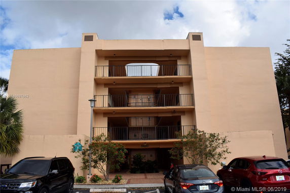 Front view of a multi-story building with balconies.