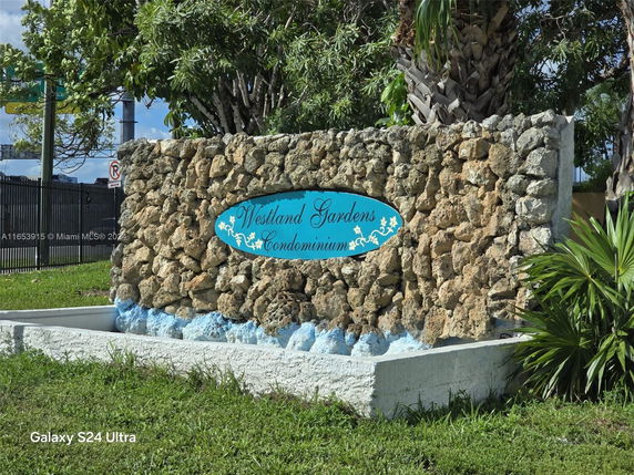 Stone wall with a sign saying 'Westland Gardens Condominium'.