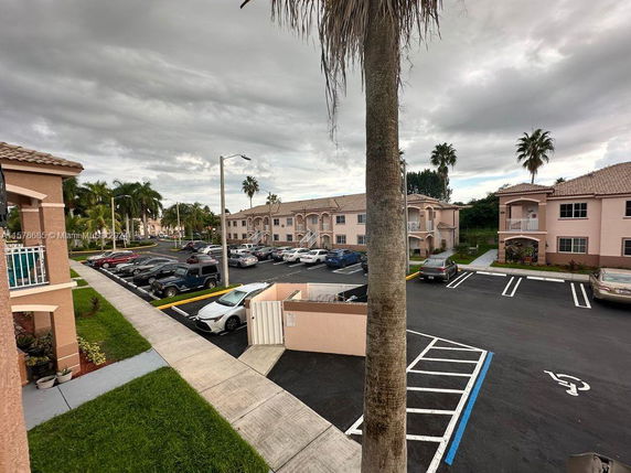 Outdoor parking area in front of apartment buildings.