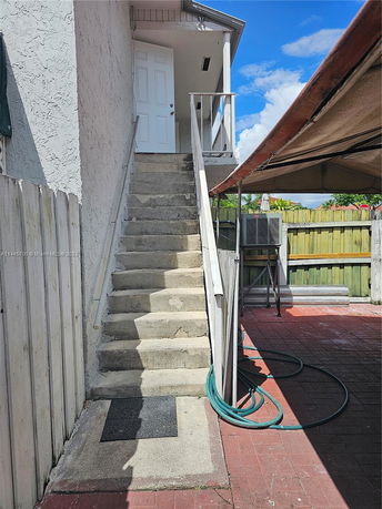 Exterior staircase leading to a door on an upper level.