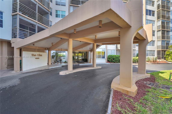 Front view of a multi-story building with a covered entrance area.