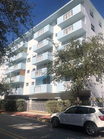 Front view of a multi-story residential building with balconies.