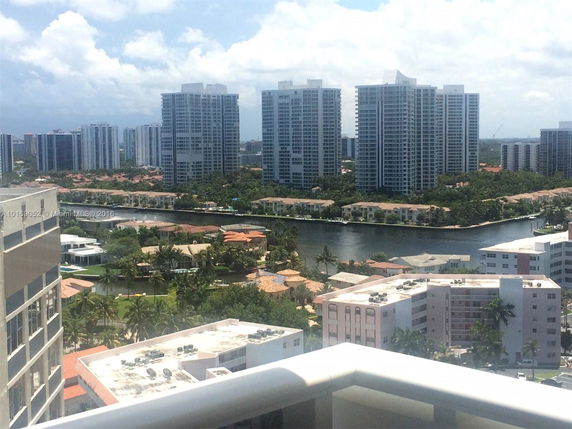 Wide angle view of high-rise buildings with a waterway and residential areas in the foreground.