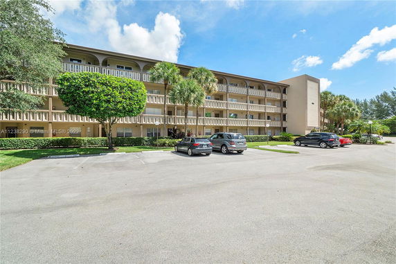 Front view of a three-story apartment building with balconies.