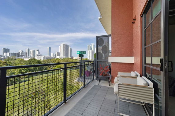 Balcony view of a cityscape with tall buildings.