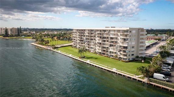 View of a multi-story residential building near a waterfront.