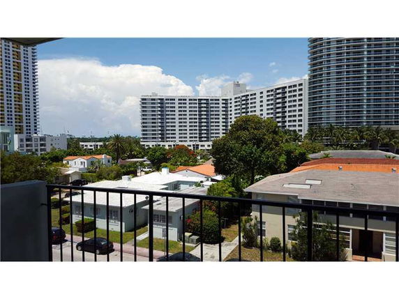 View from a building balcony showing surrounding residential and high-rise buildings.