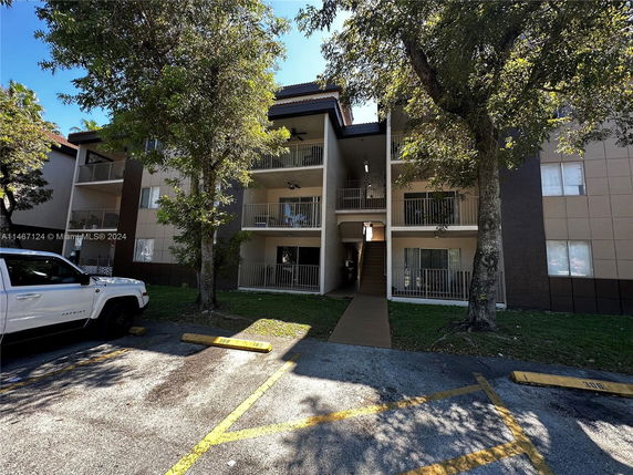 Front view of a multi-story apartment building with balconies.