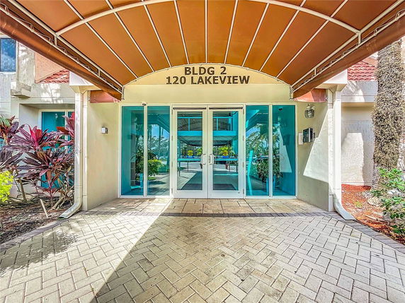 Entrance of a building with glass doors and a canopy.