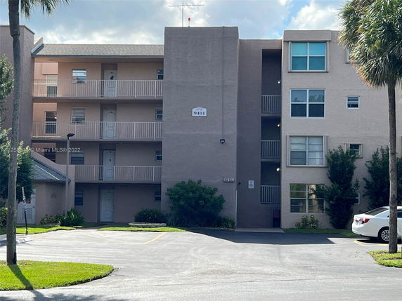 Front view of a multi-story residential building with balconies.