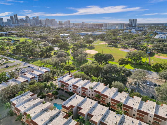 Panoramic view of a cityscape with residential buildings and a park.