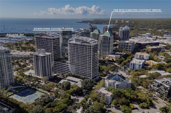 Aerial view of high-rise buildings in a coastal city with visible landmarks and waterways.