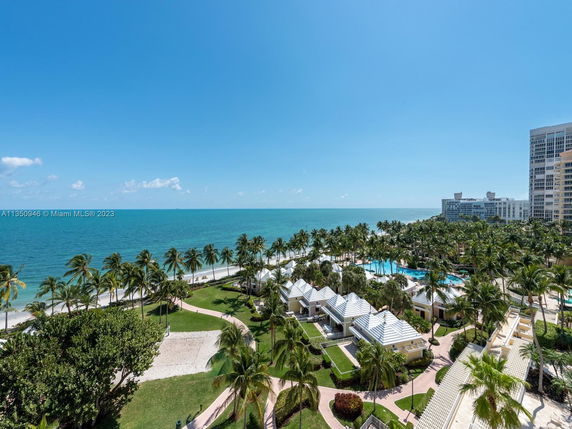 Panoramic view of beachfront area with palm trees and buildings.