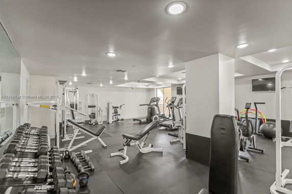 Indoor gym area with various exercise equipment.