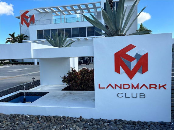 Front view of a modern building with a logo on the facade.