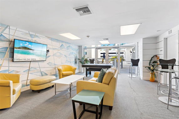 Recreational room with seating and a pool table.