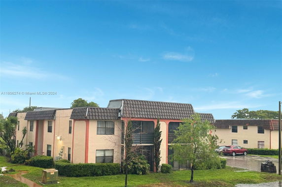 Front view of a two-story residential building with a tiled roof.
