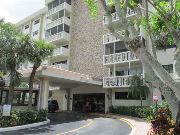 Front view of a multi-story building with a covered entrance.