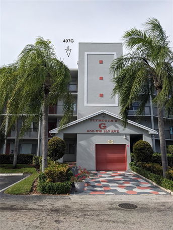 Front view of a multi-story residential building with balconies.