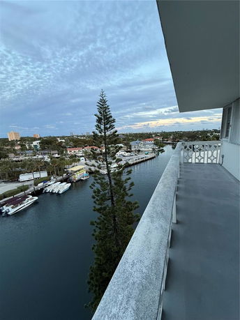 View from a high-rise building overlooking a waterway and residential area.