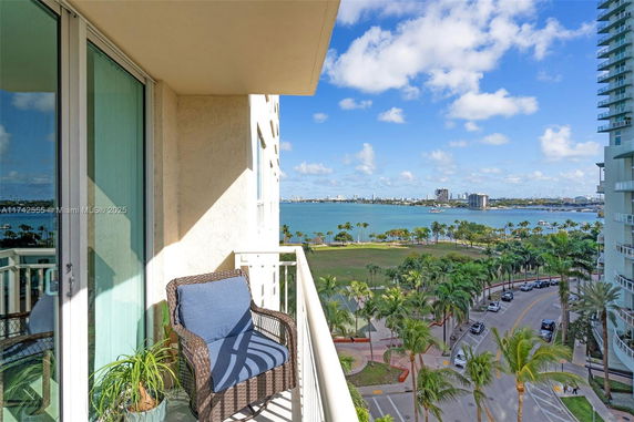 Balcony view from a building overlooking a waterfront cityscape.