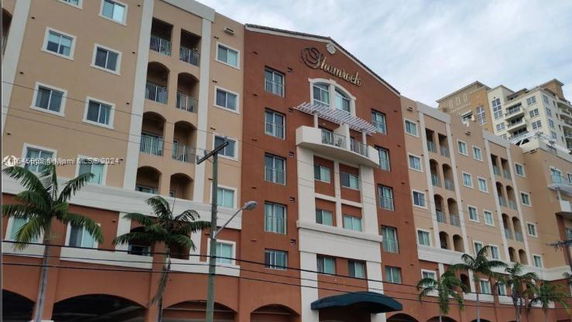 Front view of a multi-story residential building with balconies.