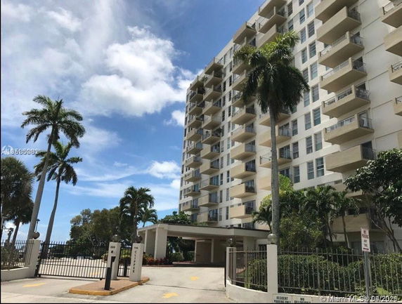 Front view of a multi-story residential building with balconies.
