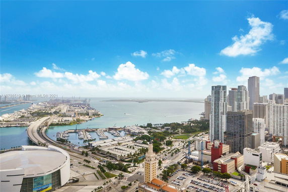 View of a cityscape with high-rise buildings and a bay area.