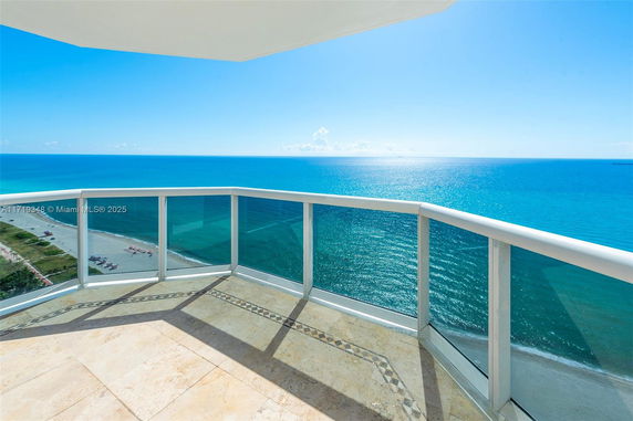Panoramic view of ocean from building balcony.