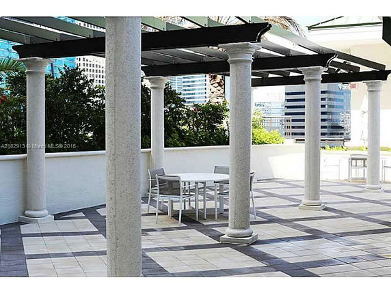 Open rooftop area with columns and outdoor seating.
