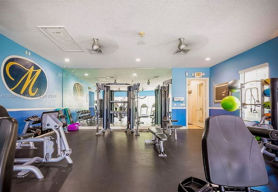 Indoor gym area with exercise equipment and blue walls.