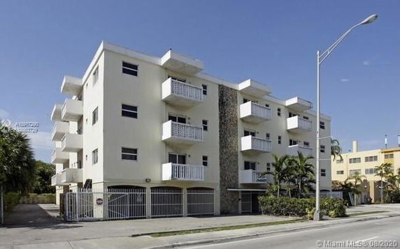 Front view of a multi-story residential building with balconies.