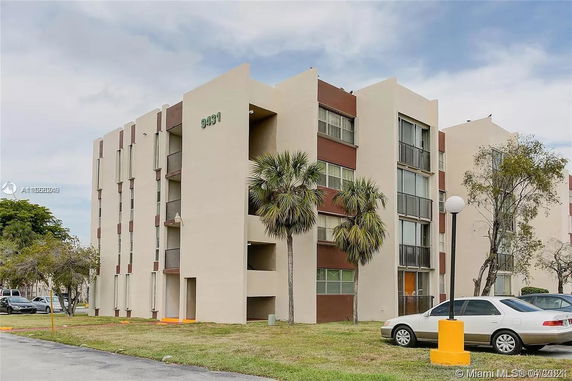 Front view of a multi-story apartment building with balconies.