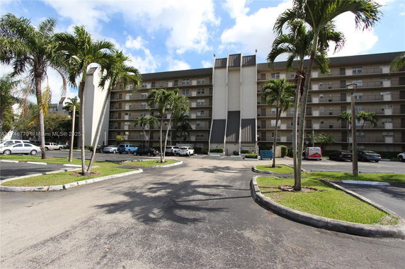 Front view of a multi-story residential building with balconies.