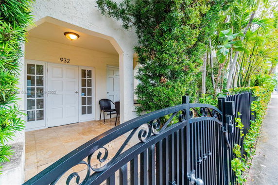 Front view of a house entrance with double doors and a small porch area.