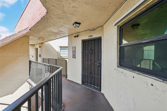 Exterior walkway and entrance to an apartment unit.