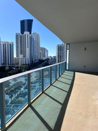 Balcony view overlooking city skyline with tall buildings.