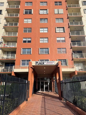 Front view of a multi-story condominium building with a prominent entrance.