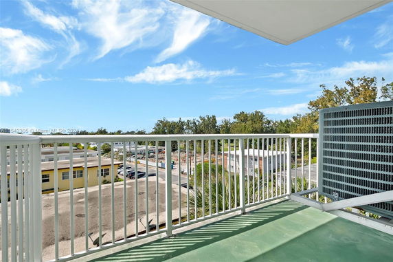 View from a balcony overlooking buildings and trees