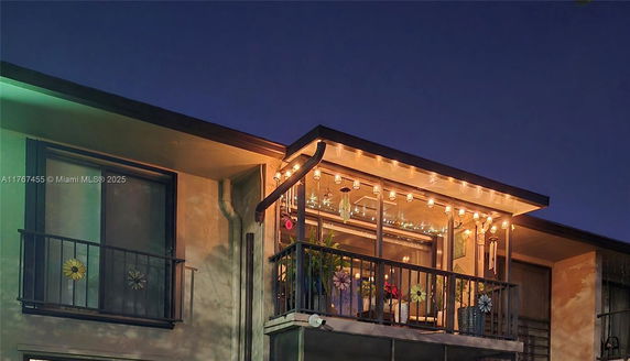 Front view of a building with decorative balcony.
