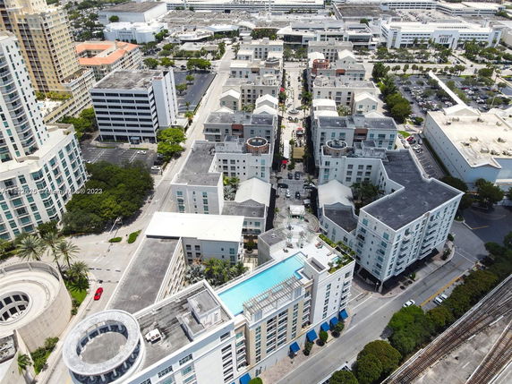 Aerial view of a cityscape with multiple buildings and streets.
